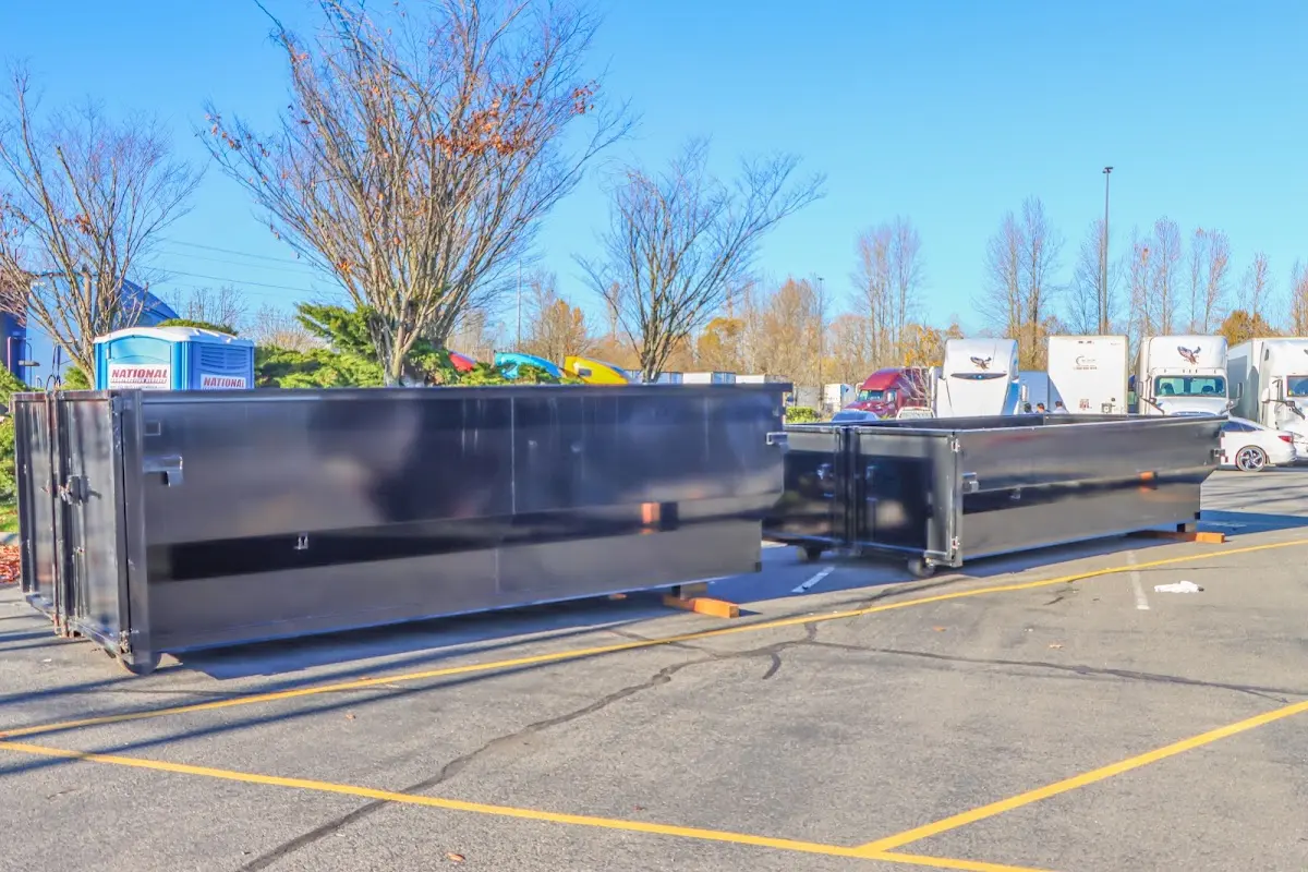 Professional dumpster rental service with roll-off container on residential driveway in Rockton